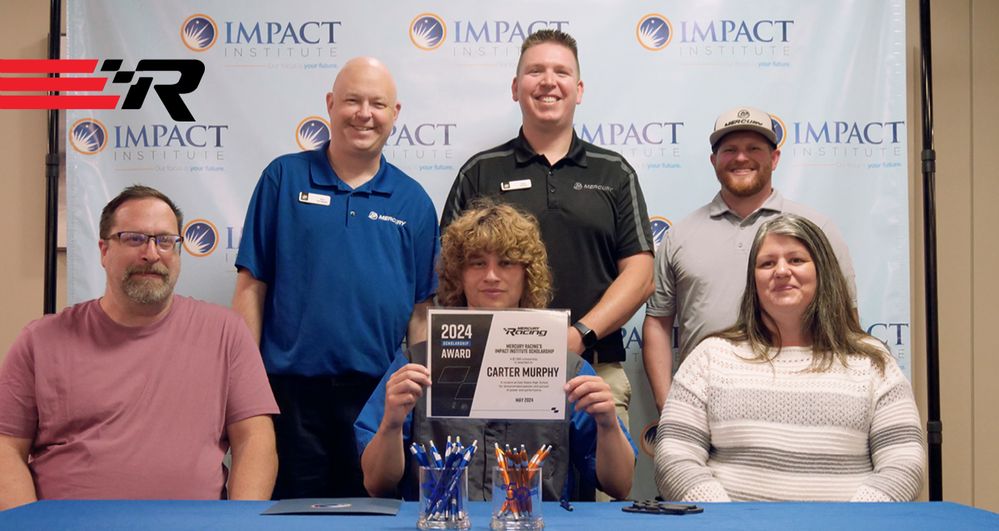 Carter Murphy, center, with family (front row) and Nick Van Nocker, Development and Operations Manager of Mercury University, Daryl Heyboer, Technical Account Manager/Workforce, and Ryan Ramsay of Impact Institute (back row).